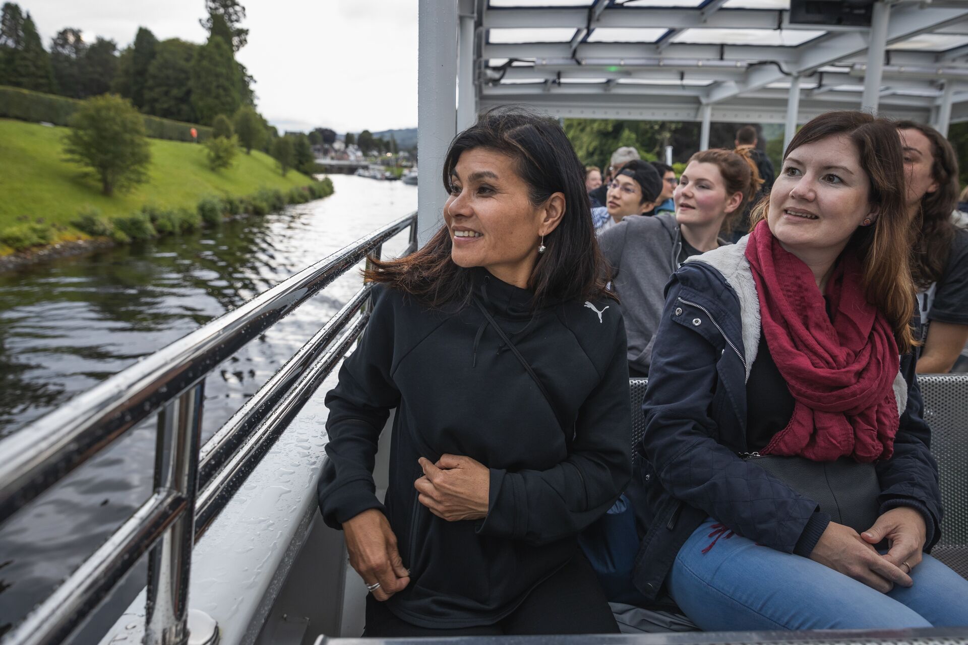 Two female travellers enjoying their Loch ness Cruise ride just after leaving fort augustus harbour