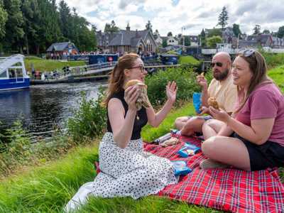 Three friends enjoying lunch by the Caledonian Canal at Fort August