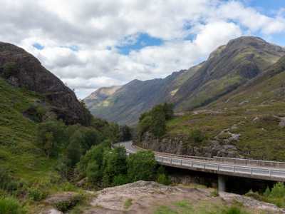 Dramatic skies above Glen Coe and winding road through the valley