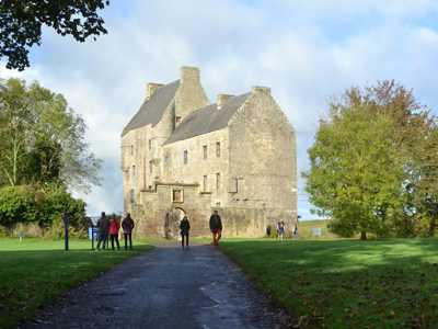 Gravel path to Midhope Castle, a 15-century tower house surrounded by lush greenery