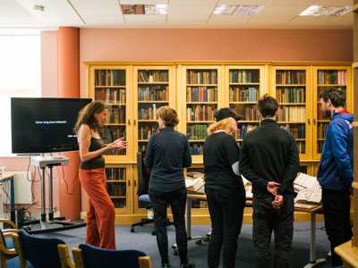 group of travellers gathered in Gaelic School library with Gaelic Librarian Expert
