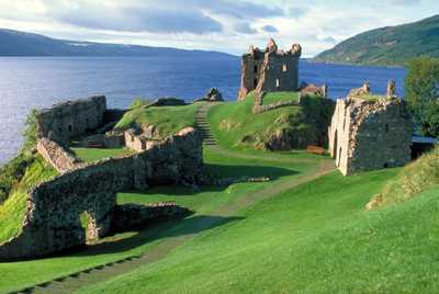 Urquhart Castle on the shores of Loch Ness, with its ancient ruins overlooking the tranquil waters and surrounding hills