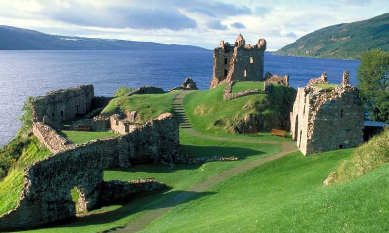 Urquhart Castle on the shores of Loch Ness, with its ancient ruins overlooking the tranquil waters and surrounding hills