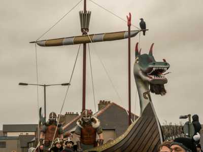 Up Helly Aa Viking longboat with intricate carvings and dragon figurehead, displayed in daylight before the burning ceremony