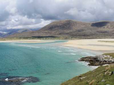 Isle of Harris with a sandy beach, turquoise sea, and rolling hills in the background