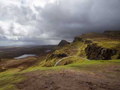Quiraing on Isle of Skye with dramatic cliffs under a cloudy sky