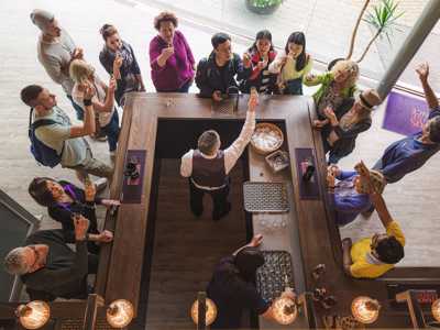 overhead view of Group of travellers sampling whisky at a Highland Whisky Distillery tour