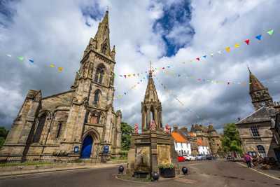 Town of Falkland with stone-wall cathedral and impressive central fountain