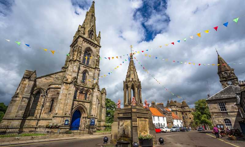 Town of Falkland with stone-wall cathedral and impressive central fountain