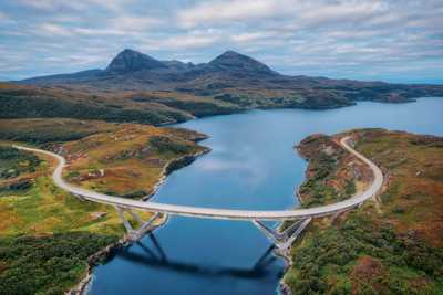 Kylesku Bridge crossing Loch a' Chàirn Bhàin, part of the North Coast 500 route, with views of mountains and water