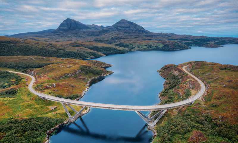 Kylesku Bridge crossing Loch a' Chàirn Bhàin, part of the North Coast 500 route, with views of mountains and water