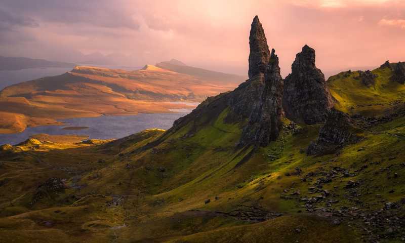 Old Man of Storr, iconic rock formation on Isle of Skye, silhouetted against a sunset.
