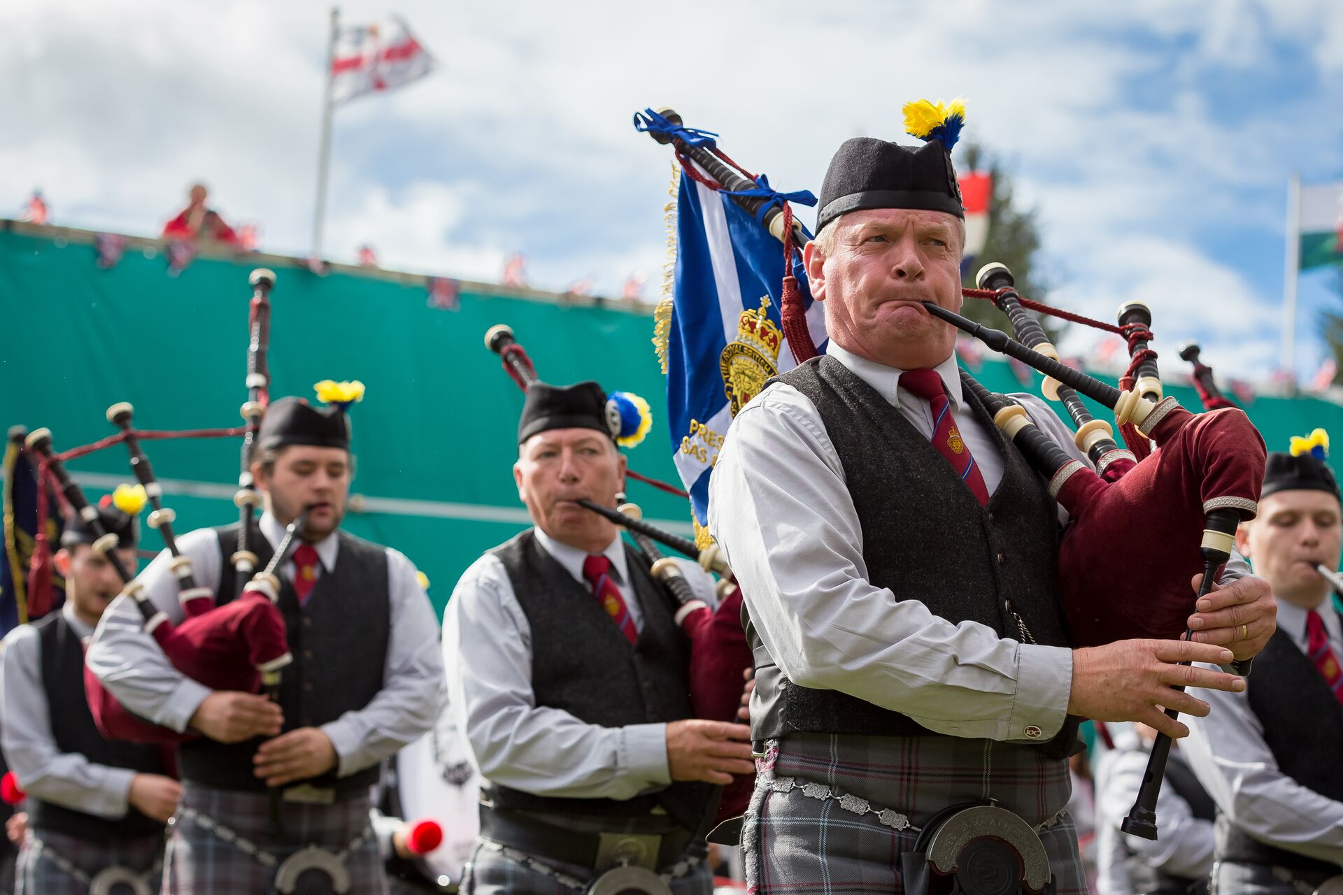 Group of Scottish bagpipers playing music at the Highland Games