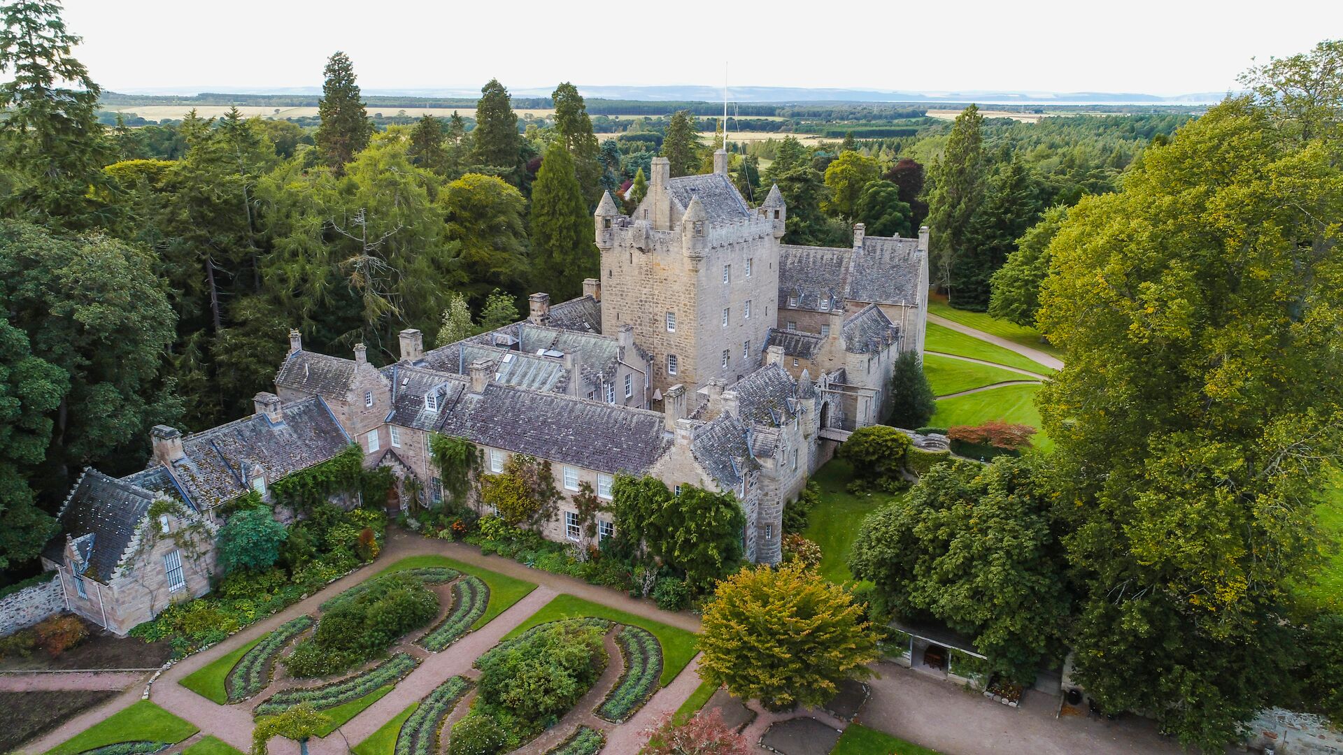 Cawdor Castle, a historic Scottish fortress surrounded by beautifully manicured gardens and lush greenery