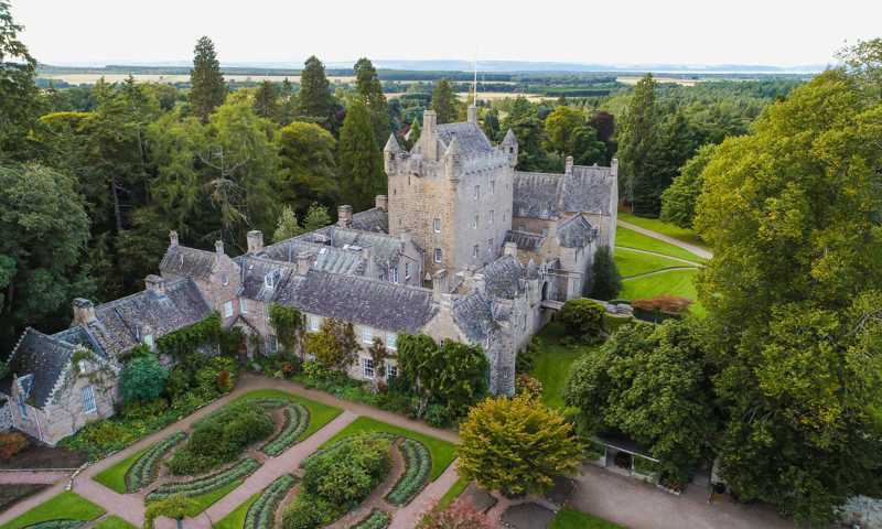 Cawdor Castle, a historic Scottish fortress surrounded by beautifully manicured gardens and lush greenery