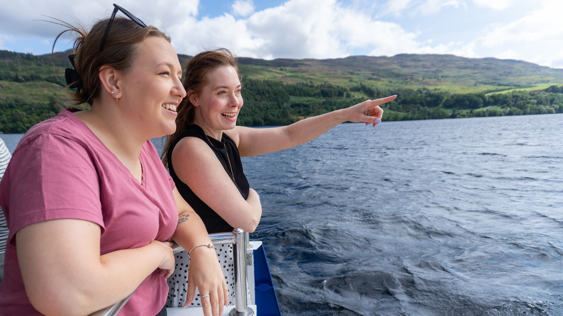 Two young women looking out for the Loch Ness Monster on the Loch Ness Boat cruise
