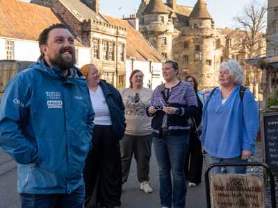 Highland Explorer Tours guide exploring Falkland with a small group of travellers