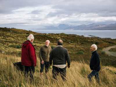 Group of volunteer and locals gathered on open ground in Tormore Forest