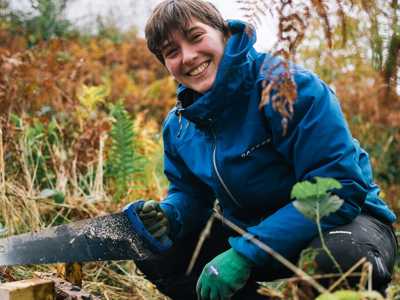 Young woman building a step in Tormore Forest